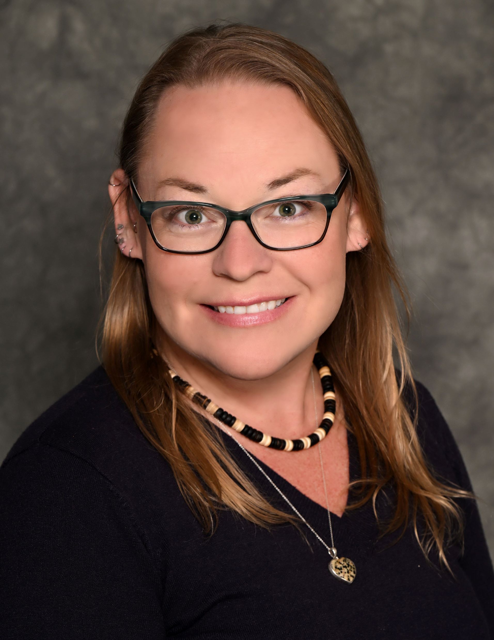 woman with blond hair and glasses